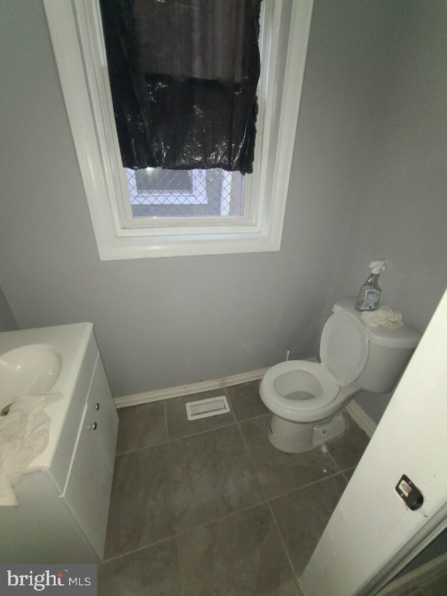 2321 W Lehigh Ave, Philadelphia, PA 19132 - bathroom with baseboards, toilet, vanity, and tile patterned floors