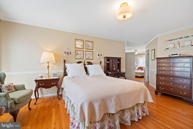 bedroom featuring wood finished floors and crown molding