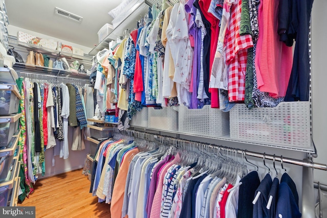 spacious closet featuring wood finished floors and visible vents
