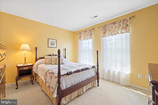 bedroom with light carpet, baseboards, and visible vents