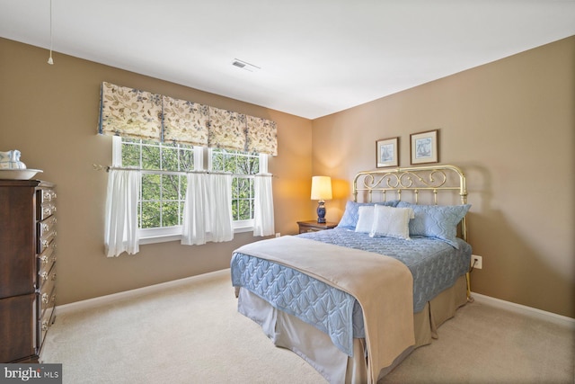 carpeted bedroom with baseboards and visible vents