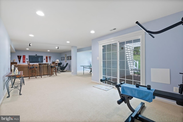 exercise area with baseboards, visible vents, recessed lighting, and light colored carpet