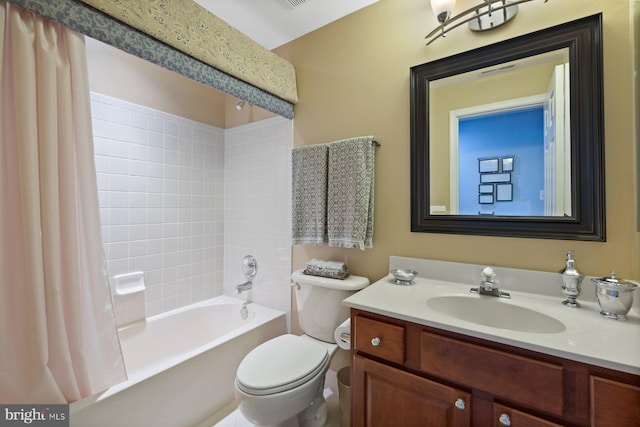 bathroom with toilet, visible vents, vanity, and shower / bath combo with shower curtain