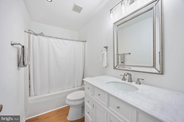 full bath with vanity, toilet, visible vents, wood finished floors, and shower / bath combination with curtain