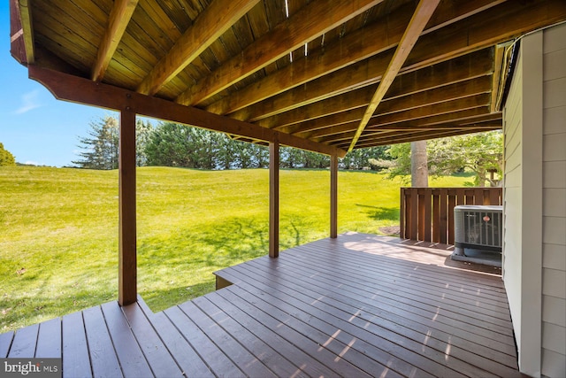 wooden terrace featuring central AC and a lawn