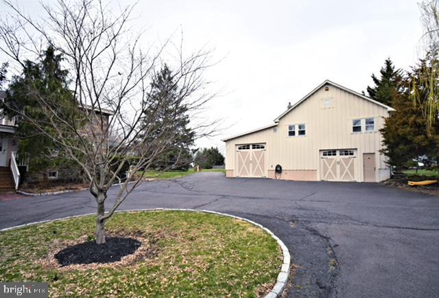 view of home's exterior featuring a garage and an outbuilding
