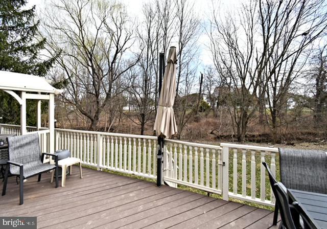 wooden terrace featuring a gazebo