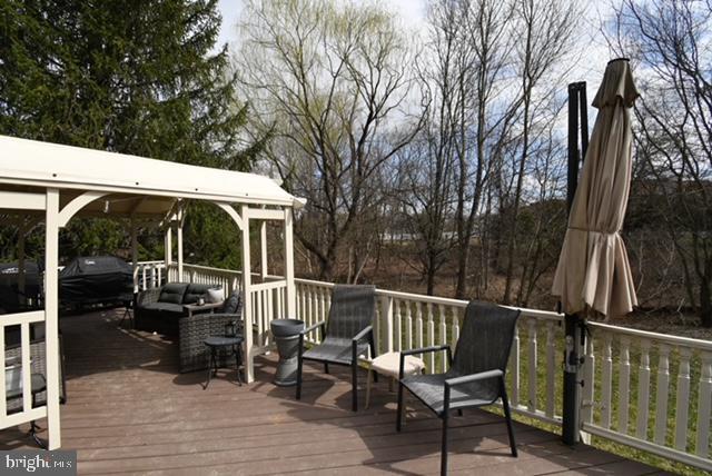 wooden terrace with an outdoor hangout area