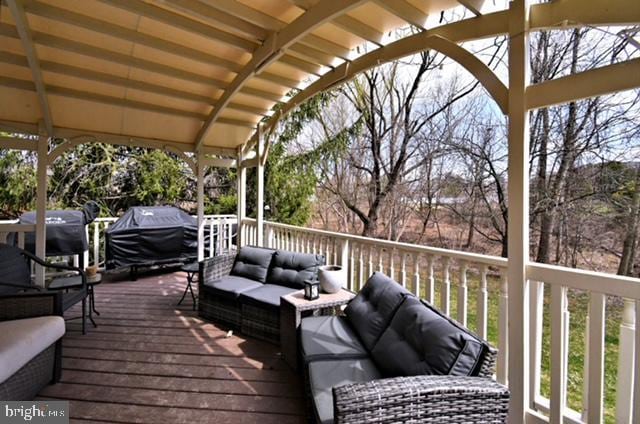 deck featuring an outdoor living space and area for grilling
