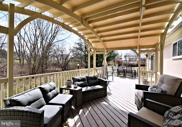 wooden terrace featuring outdoor lounge area and outdoor dining space