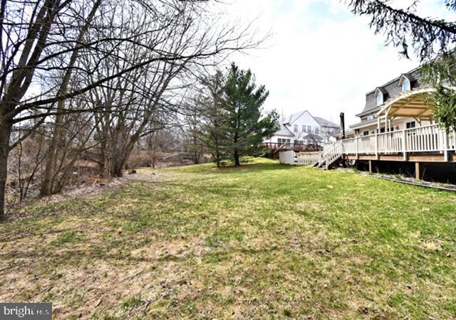 view of yard featuring stairs and a deck