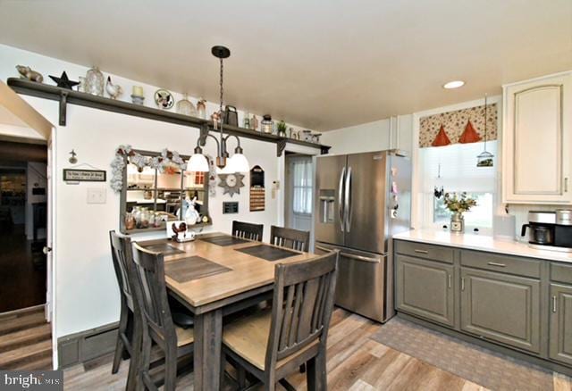 dining area featuring light wood finished floors and recessed lighting