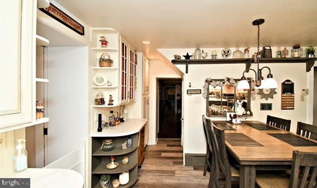 dining space featuring wood finished floors and recessed lighting