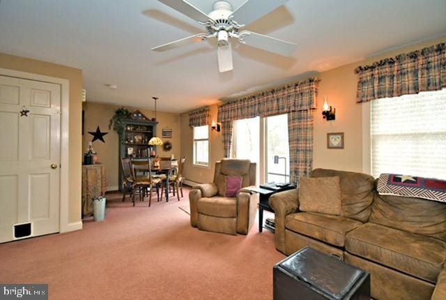 carpeted living room featuring ceiling fan