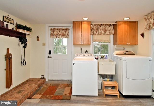 laundry room with light wood-style flooring, a sink, recessed lighting, cabinet space, and washer and dryer