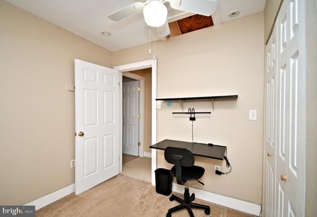 carpeted home office with baseboards and ceiling fan