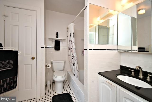 bathroom with vanity, tile patterned flooring, and toilet