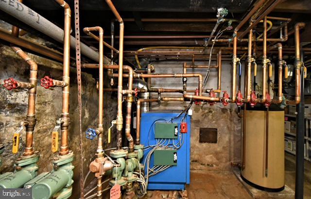 utility room with a heating unit and gas water heater