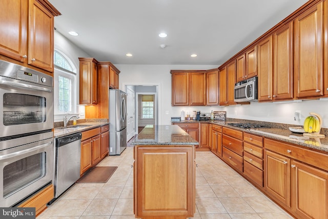 41430 Whimsical Ct, Leonardtown, MD 20650 - kitchen featuring dark stone counters, plenty of natural light, stainless steel appliances, and a kitchen island