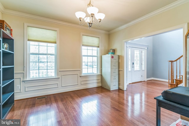 41430 Whimsical Ct, Leonardtown, MD 20650 - interior space featuring crown molding, wood finished floors, wainscoting, an inviting chandelier, and visible vents