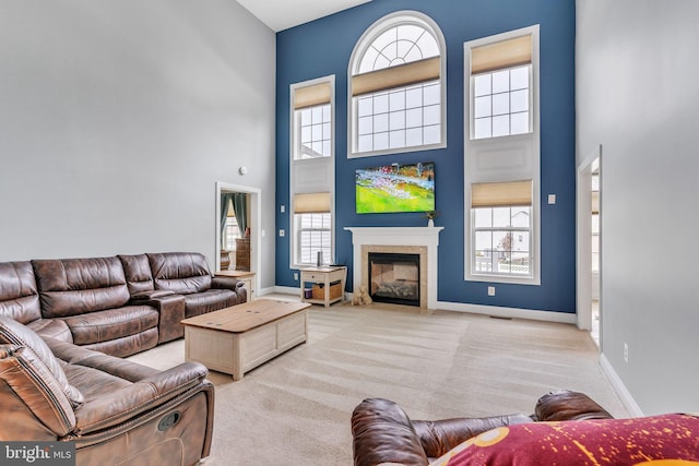 41430 Whimsical Ct, Leonardtown, MD 20650 - living area featuring plenty of natural light, a glass covered fireplace, a towering ceiling, and carpet