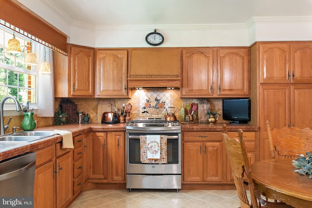 kitchen featuring backsplash, stainless steel appliances, brown cabinets, and a sink