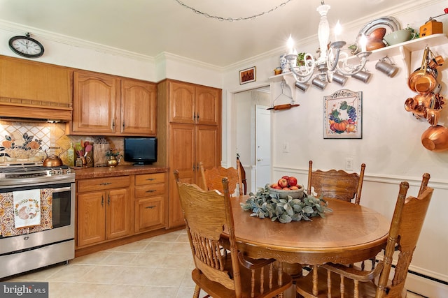 dining area with light tile patterned floors and crown molding