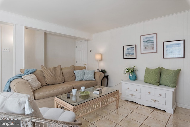 living area with crown molding and light tile patterned flooring