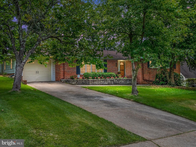 view of front facade with an attached garage, driveway, a front lawn, and brick siding