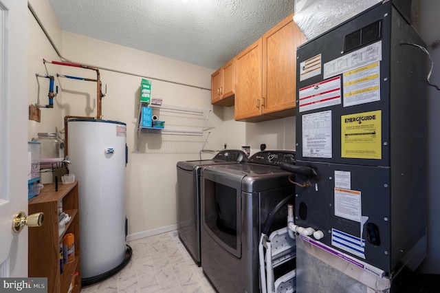 clothes washing area with cabinet space, water heater, marble finish floor, washing machine and dryer, and heating unit