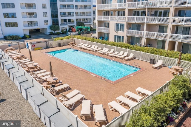 pool featuring a patio area and fence