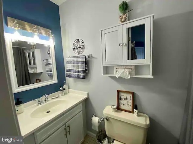bathroom featuring vanity and toilet