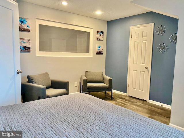 bedroom featuring wood finished floors, baseboards, and recessed lighting