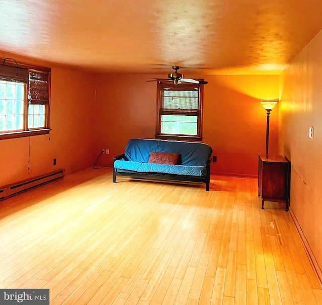 3080 Beautiful Run Rd, Orange, VA 22960 - sitting room featuring healthy amount of natural light, light wood-style floors, ceiling fan, a baseboard heating unit, and a textured ceiling