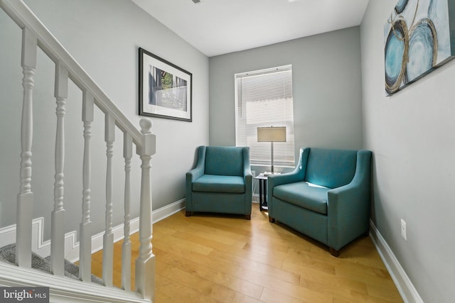 2519 Reisterstown Rd, Baltimore, MD 21217 - living area with light wood-style floors, stairs, and baseboards