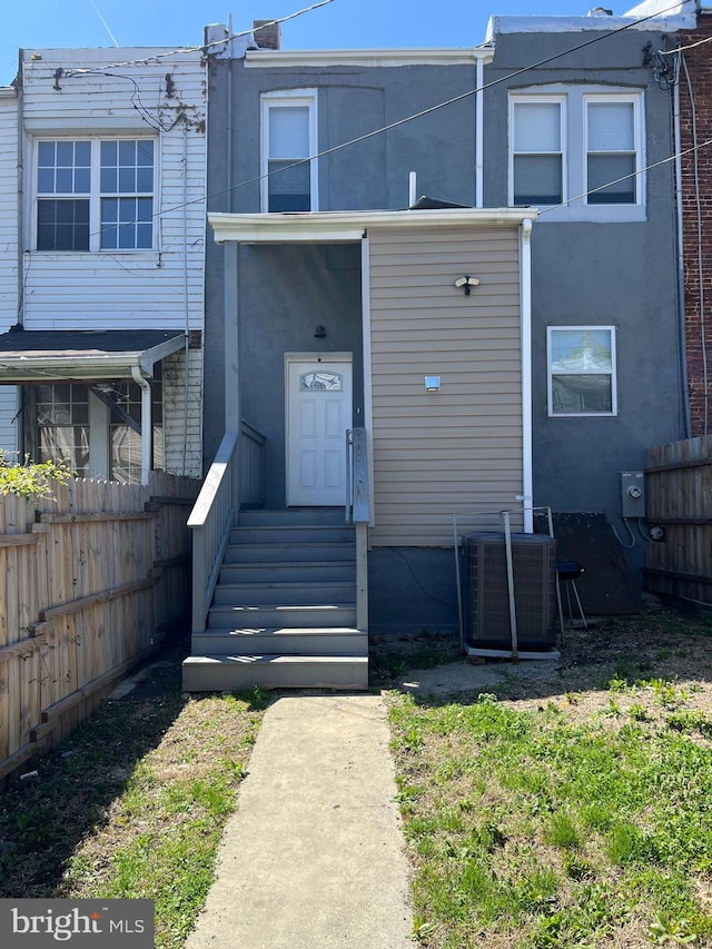 2519 Reisterstown Rd, Baltimore, MD 21217 - view of property with central AC unit, fence, and stucco siding