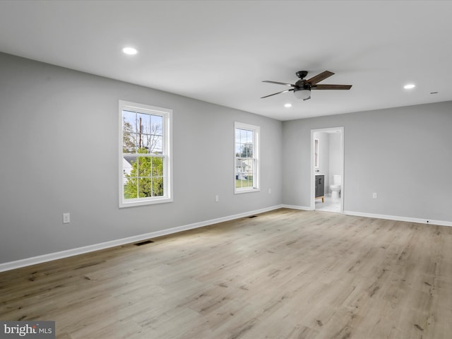 spare room featuring ceiling fan, light wood-style flooring, baseboards, visible vents, and recessed lighting