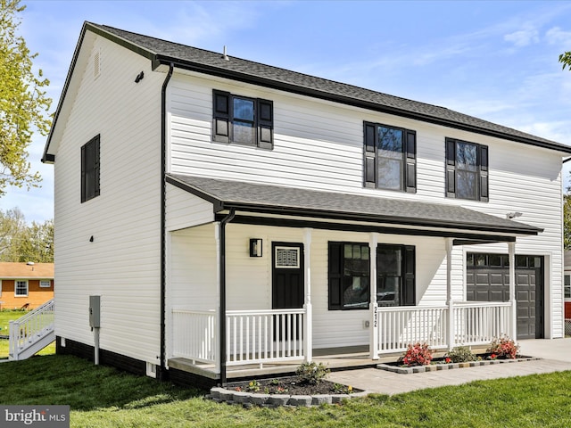 traditional home with an attached garage, covered porch, a front yard, and concrete driveway