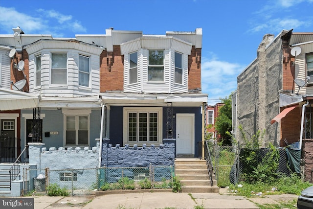 5449 Race St, Philadelphia, PA 19139 - multi unit property featuring a porch, a gate, and a fenced front yard
