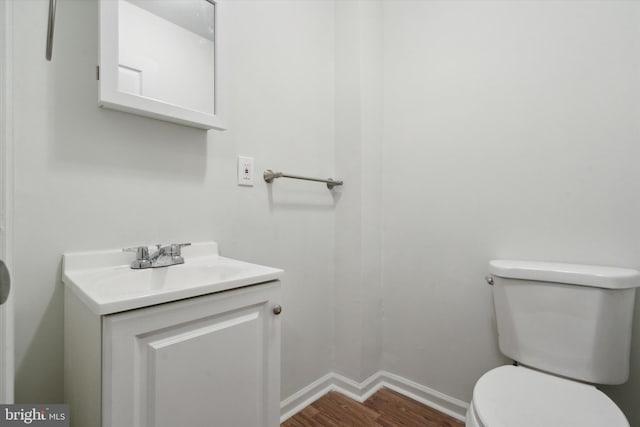 5449 Race St, Philadelphia, PA 19139 - half bath featuring toilet, wood finished floors, vanity, and baseboards