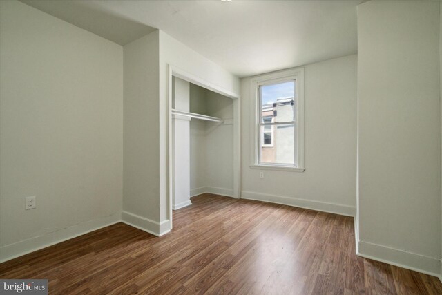 5449 Race St, Philadelphia, PA 19139 - unfurnished bedroom featuring wood finished floors, baseboards, and a closet