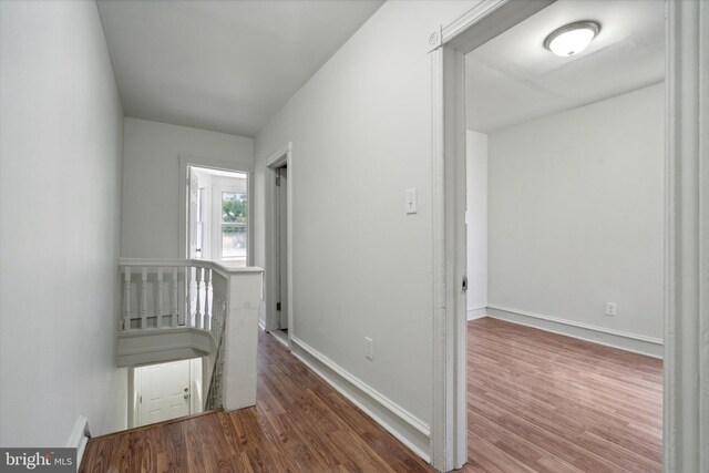 5449 Race St, Philadelphia, PA 19139 - hallway featuring wood finished floors, baseboards, and an upstairs landing