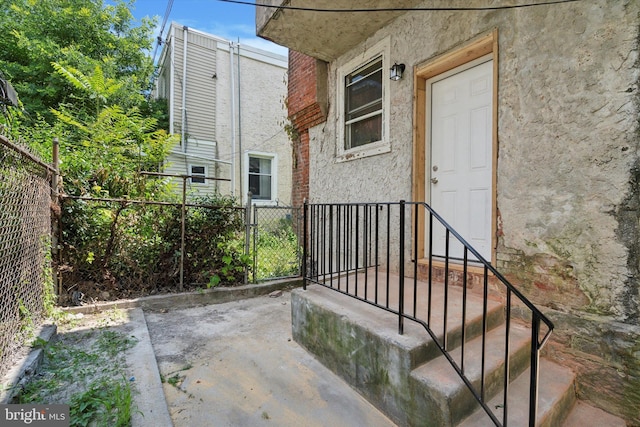 5449 Race St, Philadelphia, PA 19139 - property entrance featuring stucco siding and fence