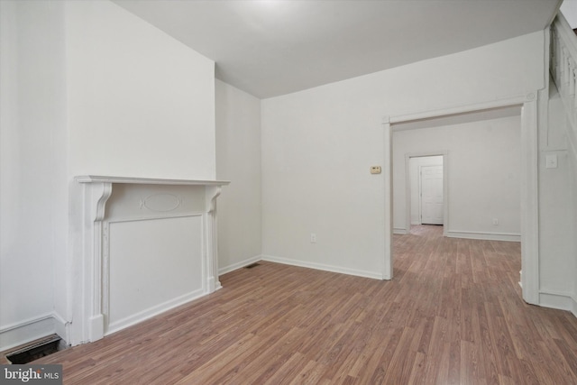 5449 Race St, Philadelphia, PA 19139 - unfurnished living room featuring light wood-style flooring and baseboards