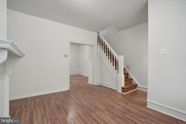 5449 Race St, Philadelphia, PA 19139 - unfurnished living room featuring wood finished floors, baseboards, and stairs