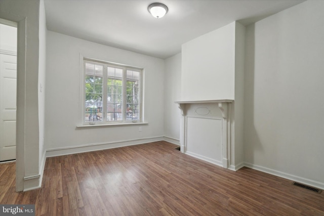 5449 Race St, Philadelphia, PA 19139 - unfurnished living room featuring visible vents, baseboards, and wood finished floors
