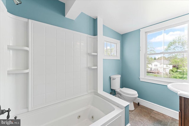 full bath featuring a combined bath / shower with jetted tub, vanity, toilet, and baseboards