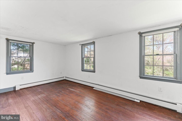unfurnished room with baseboard heating, a healthy amount of sunlight, and hardwood / wood-style floors
