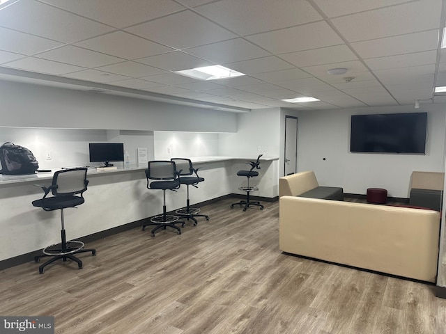 office area featuring wood finished floors, built in study area, and baseboards