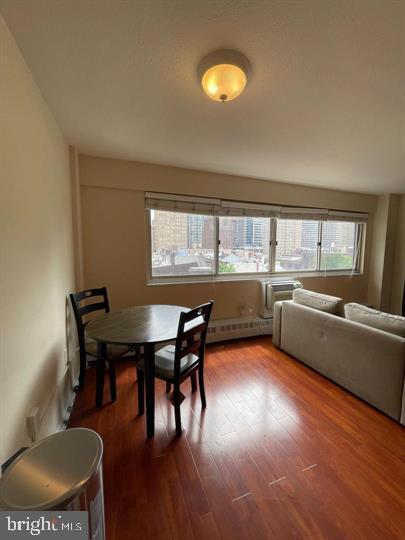 dining area with dark wood-style floors